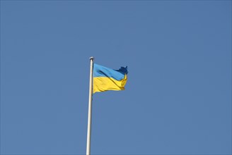 Ukrainian flag of Ukraine over blue sky