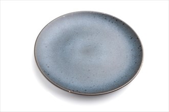 Empty blue ceramic plate isolated on white background. Side view, close up