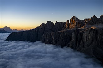 Sunrise over a sea of fog with the peaks of the Sella massif in the background, Corvara, Dolomites,