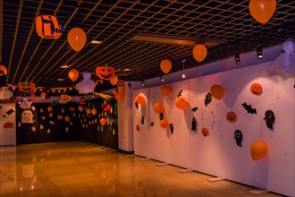 Dimly lit room decorated with hand made Halloween decorations of ghost, jack-o-lanterns and