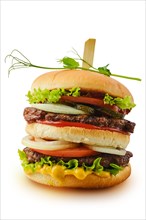 Big double beef burger with fresh vegetables isolated on white
