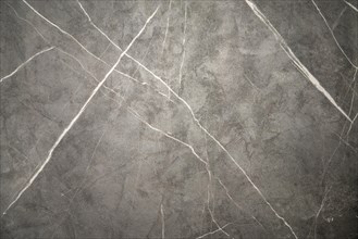 A close-up of grey marble with natural white veins