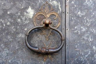 Door knocker on an old metal gate in the historic centre, Genoa, Italy, Europe