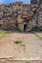 Interior stone and brick wall of castle ruins with opening for egress in Istanbul, Tuerkiye