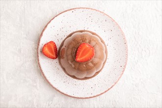 Chocolate jelly with strawberry on gray concrete background. top view, flat lay, close up