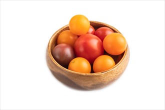 Red. yellow cherry tomatoes in wooden bowl isolated on white background. Side view