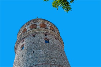 Low angle view of Galata tower in Istanbul against blue sky in Istanbul, Tuerkiye