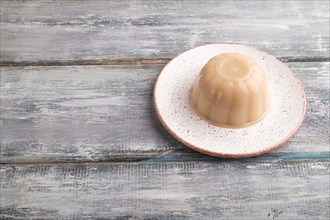 Buckwheat milk jelly on gray wooden background. side view, copy space