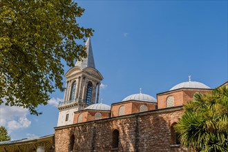 Exterior of mosque with spire against blue sky in Istanbul, Turkiye