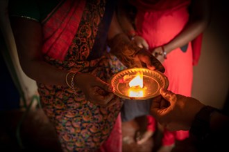Indian woman holding oil lamp, Aarti light ritual, worship to the divine, Tamil Nadu, India, Asia