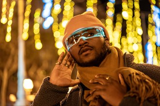 African man listening while using smart glasses in the city at night
