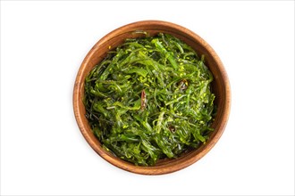 Chuka seaweed salad in brown wooden bowl isolated on white background. Top view, flat lay