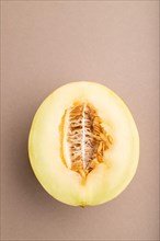 Sliced ripe yellow melon on brown pastel background. Top view, flat lay, copy space. harvest, women