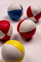 Five juggling balls on a white background, selective focus, studio shot, Germany, Europe