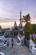 View from the dragon staircase of buildings with colourful mosaics, Park Güell entrance, dawn,