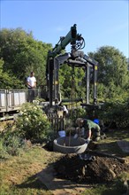 Delivery and installation of concrete ring for domestic septic tank system, Suffolk, England, UK