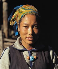 Portrait of pretty Bhotia girl with headscarf at the village of Chhinga in the Mustang region of