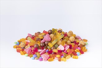 A colourful pile of different sweets on a white background, copy room