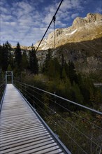 Suspension bridge at Lac Tseuzier reservoir, lake, mountain lake, landscape, autumnal, summery,