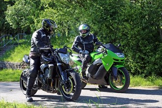 Two motorcyclists on a short stopover