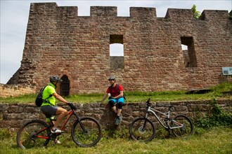 Mountain bikers take a break at the Wolfsburg above Neustadt in the Palatinate Forest, Germany,