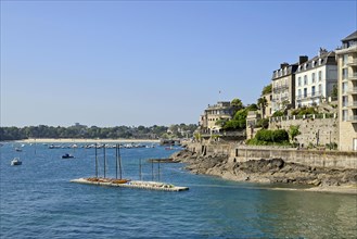 Fortified coastline with buildings on the rocky shore in Dinard, Ille-et-Vilaine, Brittany, France,
