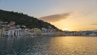 Town view at dusk with houses on the waterfront and mountains in the background, Taygetos