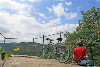 Mountain biker enjoys the view of the Palatinate Forest above Neustadt an der Weinstrasse