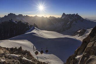 Mountain railway in front of glacier and mountains, sunbeams, backlight, Aiguille du Midi, Mont