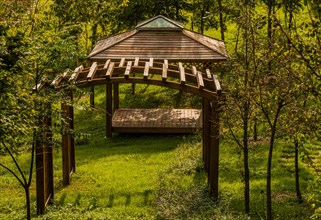 Wooden trellis in front of covered picnic pavilion in wilderness park in South Korea