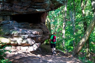 Hikers in the Dahner Felsenland . The many red sandstone rock formations characterise this region