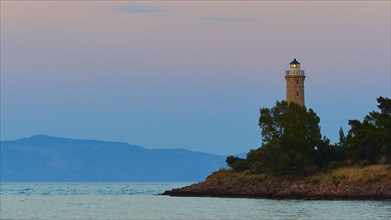 Silhouette of a lighthouse at dusk, a peaceful scene by the sea, Gythio, Mani, Peloponnese, Greece,
