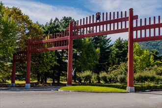 Large wooden Japanese style gate across four lane road in public park in South Korea