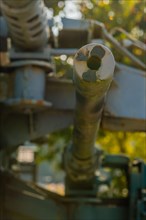 Closeup of machine gun muzzle with barrel, turret and mount blurred out in background