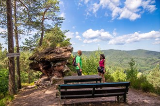 Hikers at the Haeusel-Stein viewpoint in the Palatinate Forest