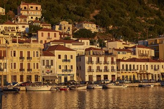The harbour with sailing boats shines in the golden light of the sunset, Gythio, Mani, Peloponnese,