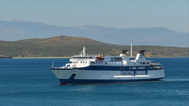 Large white ferry on blue sea with clear sky, en route to a destination, Gythio, Mani, Peloponnese,