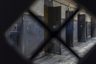 View through a grille of the wing with prisoners' cells in the former Presidio prison, Presidio