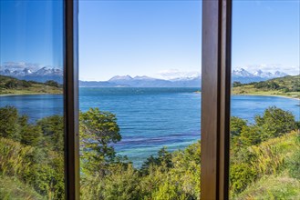 Reflection in a window: View across the Beagle Channel to the mountains of Hoste Island Chile,