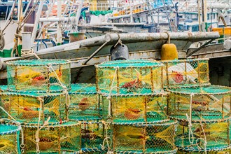 Closeup of large yellow and blue crab cages used to bait, lure, and catch crabs for commercial or