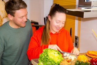 Young couple cooking vegan food