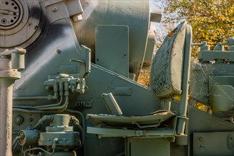 Side view of external seat on military artillery vehicle on display in public park