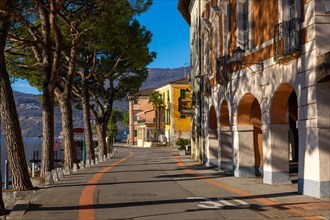 Old Beautiful Town with Building and Trees on the Waterfront on Lake Lugano in a Sunny Day with