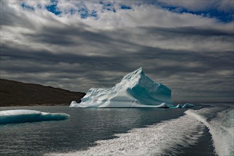 Boat passing icebergs in a fjord, Qaqortoq, Greenland, Denmark, North America