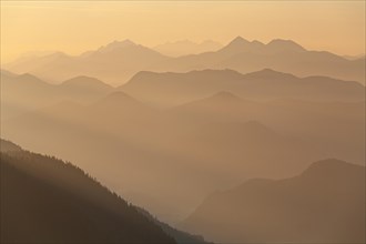 Mountain peak in the haze, sunrise, summer, view from Jochberg to Bavarian Alps, Upper Bavaria,