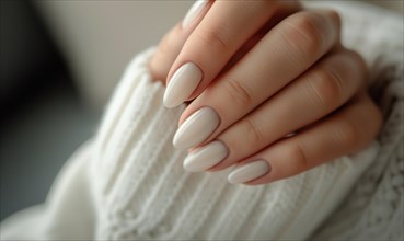 Female hand with white nail design. Glitter white nail polish manicure. Woman hand with white