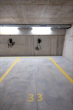 Illuminated Underground Parking Lot with Number and Electric Car Charger in Switzerland