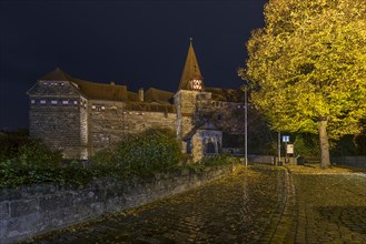 Wenzelburg or Lauf Imperial Castle illuminated at night on a rainy autumn day, rebuilt by Emperor