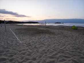 Morning atmosphere on the beach at sunrise, beach volleyball court, Lopar, island of Rab, Kvarner