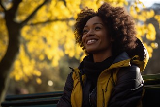 Young African American woman relaxed and happy in a park in autumn, AI generated